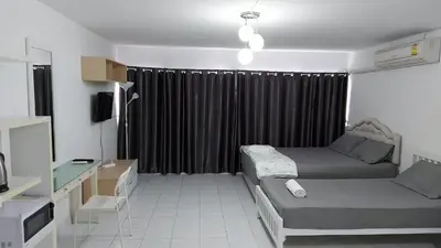 a small room with a bed and a window at CT Impact in Thung Si Kan