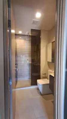 a bathroom with a shower and a toilet and a sink at High Rise Designer Gem Central Bangkok City View in Bangkok