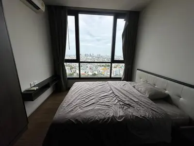 a bed in a bedroom with a large window at High Rise Designer Gem Central Bangkok City View in Bangkok