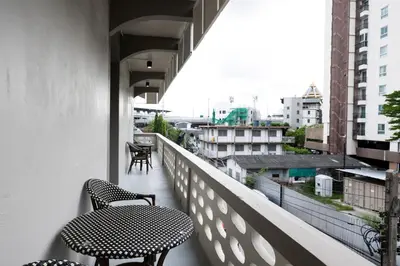 a balcony with two chairs and a table at ดอนเมือง 201 Near DMK airport BTS Wat PhraSi in Bang Khen