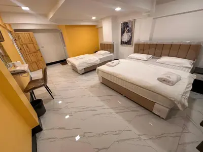 two beds in a room with a marble floor at Siam Boutique Hotel in Bangkok