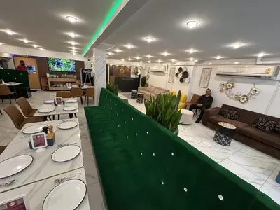 a lobby with a person sitting on a couch at Siam Boutique Hotel in Bangkok