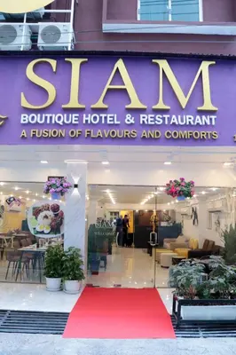 a red carpet in front of a hotel with a sign at Siam Boutique Hotel in Bangkok