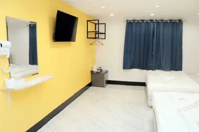a hospital room with two beds and a mirror at Siam Boutique Hotel in Bangkok