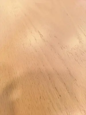 a close up of a wooden table with scratches on it at MSHomeStay 5388 in Bangkok
