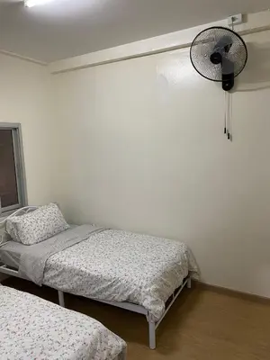 a bedroom with two beds and a fan at PAMA'Pranakorn in Bangkok