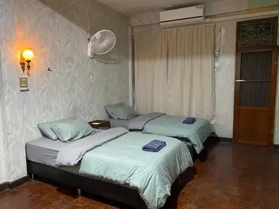 a room with three beds in a room at PAMA'Pranakorn in Bangkok