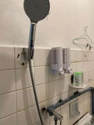 a shower head on the wall of a bathroom at PAMA'Pranakorn in Bangkok