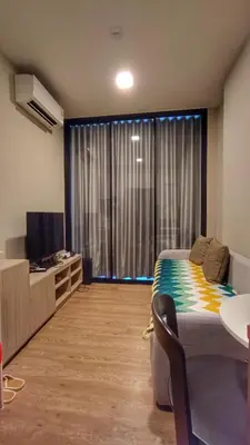 a bedroom with a bed and a tv and a window at Plum New West - Pool View in Ban Bang Krabu