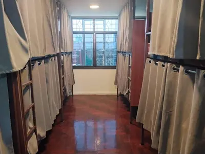 a hallway with curtains in a room with a window at The Green Bean Hostel Khaosan in Bangkok