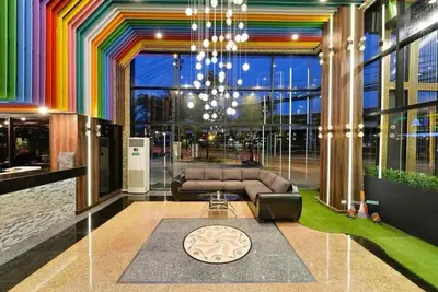 a colorful living room with a couch and a chandelier at THE BRETON Hotel in Ban O Pao