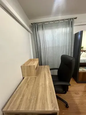 a desk and a chair in a room with a bed at Panoramic sky city view 1 BR at MRT Bangson By Orn in Bangkok