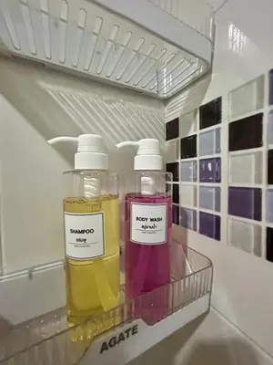 two bottles of oils sitting on a shelf in a refrigerator at Panoramic sky city view 1 BR at MRT Bangson By Orn in Bangkok