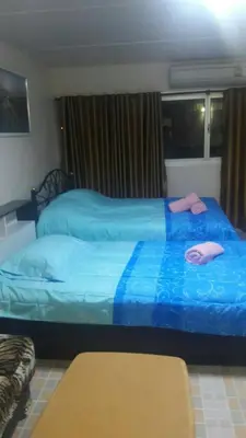 a bedroom with two beds with blue sheets at Smart Residence@Muengthongthani in Nonthaburi
