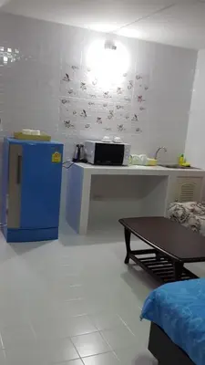 a kitchen with a counter and a table in a room at Smart Residence@Muengthongthani in Nonthaburi