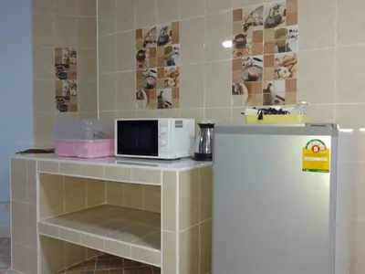 a kitchen with a microwave and a refrigerator at Smart Residence@Muengthongthani in Nonthaburi