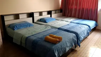 two beds sitting next to each other in a bedroom at Smart Residence@Muengthongthani in Nonthaburi