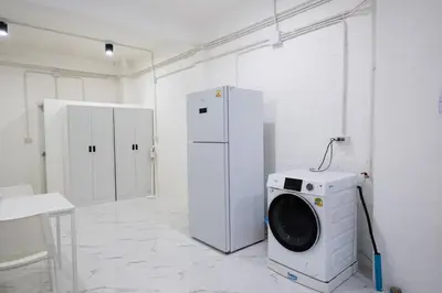 a laundry room with a washing machine and a refrigerator at ดอนเมือง 203 Near DMK Airport BTS Wat PhraSi in Bang Khen
