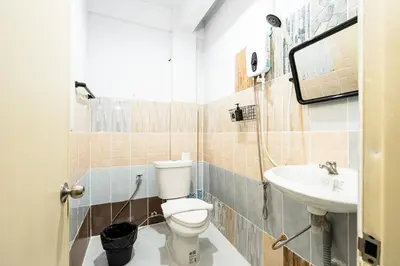 a bathroom with a toilet and a sink at BAO The Giant Swing - เบา ศาลเจ้าพ่อเสือ ถนนตะนาว in Bangkok