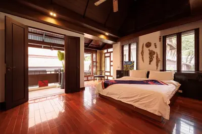 a bedroom with a large bed in a room with windows at CBD Private Pool Villa Nanny Free Thai costumes 24hrs Security Breakfast in Bangkok