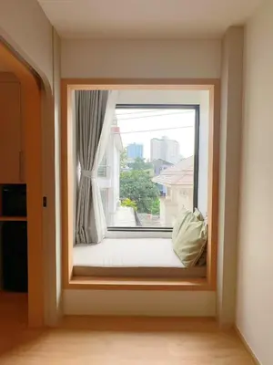 a window seat with a view of a city at Wynora Hotel in Khlong Toei