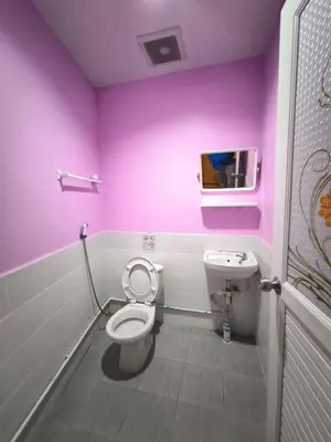 a pink bathroom with a toilet and a sink at Santo house no66 in Bangkok