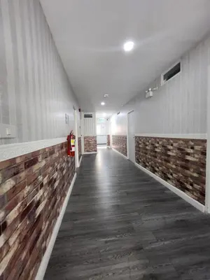 an empty hallway of a building with a brick wall at 101Hotel in Ban Na Song