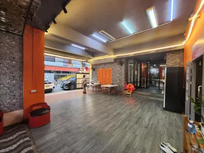 an empty lobby with a table and a car garage at 101Hotel in Ban Na Song