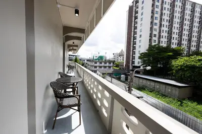 a balcony with chairs and a view of a city at ดอนเมือง 301 Near DMK Airport BTS Wat PhraSi in Bang Khen
