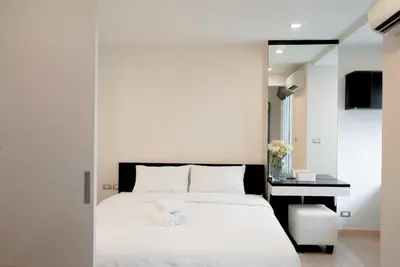 a bedroom with a white bed and a desk at 5 mins to BTS Ekkamai, One Bed Fully-Furnished in Bangkok