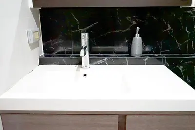 a sink with a faucet on top of a counter at 5 mins to BTS Ekkamai, One Bed Fully-Furnished in Bangkok