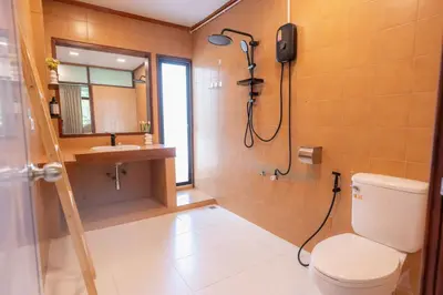 a bathroom with a shower and a toilet and a sink at Stay Ekkamai - Private Pool villa, Central Bangkok in Bangkok