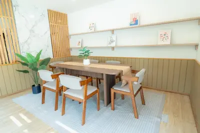 a dining room with a wooden table and chairs at Stay Ekkamai - Private Pool villa, Central Bangkok in Bangkok