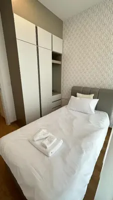 a white bed with two towels on top of it at 2BR Apartment near SiamPlatinumCentral World in Bangkok