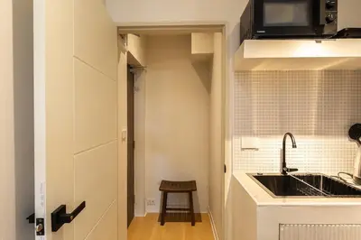 a small kitchen with a sink and a counter at Cute & Comfy Studio for 3 guests at Center of Sathorn in Bangkok