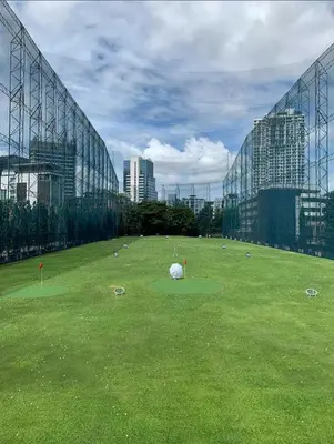 a large green field in front of a glass building at Page65-Bangkok Urban Light & City Rhythm -Ekkamai in Bangkok