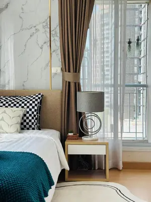 a bedroom with a bed and a table with a lamp at Page65-Bangkok Urban Light & City Rhythm -Ekkamai in Bangkok