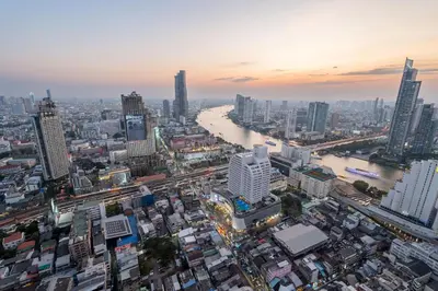 an aerial view of a city with a river and buildings at Hangover State Tower Stunning River View in Bangkok