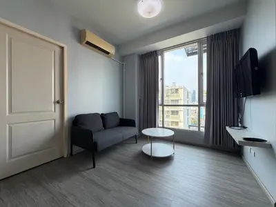 a living room with a couch and a window at Pano Ratchada 19 BKK MRT in Bangkok