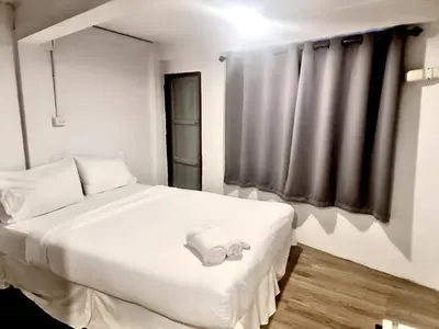 a bedroom with a white bed and a window at Znap Yaowarat - MRT Wat Mangkon in Samphanthawong
