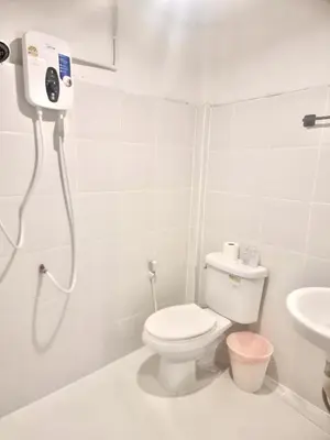 a white bathroom with a toilet and a sink at Znap Yaowarat - MRT Wat Mangkon in Samphanthawong