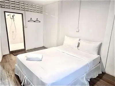 a white bedroom with a large white bed and a mirror at Znap Yaowarat - MRT Wat Mangkon in Samphanthawong