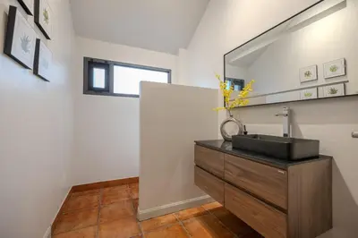 a bathroom with a sink and a mirror at Thong Lo Private Pool Villa In Center Of Bangkok in Bangkok