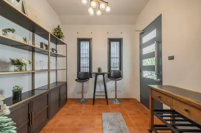 a room with two chairs and a table in it at Thong Lo Private Pool Villa In Center Of Bangkok in Bangkok