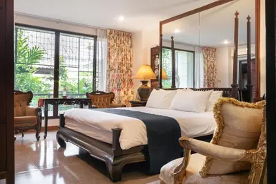 a bedroom with a large bed with a large mirror at Star House Classic Style in Bangkok