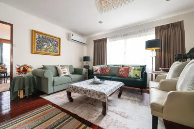 a living room with two couches and a coffee table at Star House Classic Style in Bangkok