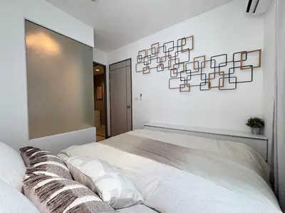 a bedroom with a large bed and a large mirror at Ideo Mix Sukhumvit 103, right next to BTS Udomsuk in Phra Khanong