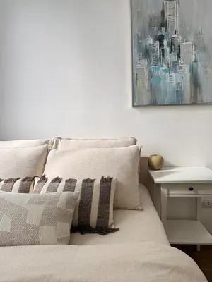 a bedroom with a bed with a picture on the wall at Ideo Mix Sukhumvit 103, right next to BTS Udomsuk in Phra Khanong