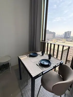 a table and chairs with a view of a city at Ideo Mix Sukhumvit 103, right next to BTS Udomsuk in Phra Khanong