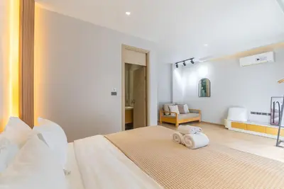 a bedroom with a bed with two towels on it at Heart \u7d20\u5764\u903836 Chewaheart Sukhumvit 36 in Bangkok